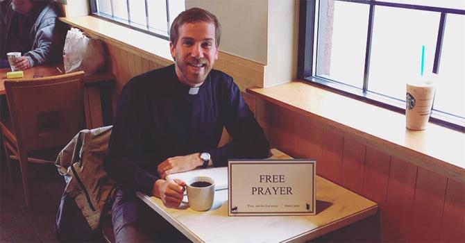 Thomas Rusert waits for coffee shop patrons to take up his offer for free prayer. (Photo/courtesy of Thomas Rusert)