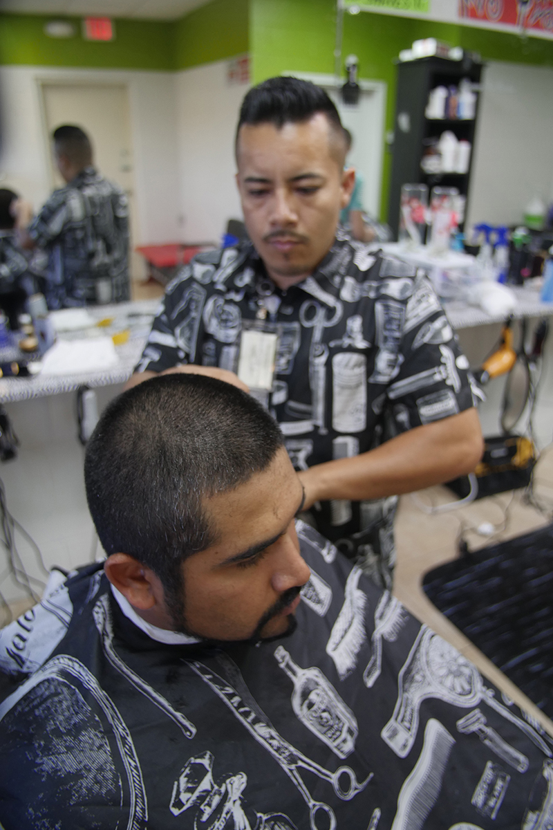 Antonio Galeno cuts a client's hair at 5 Stars Barbershop in Peñitas, Texas. (Photo/Buckner)