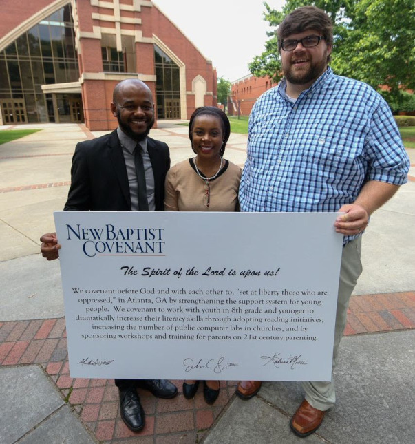 Michael Wortham of Ebenezer Baptist Church, Katrina Moore of the Greater Piney Grove Baptist Church and Trey Lyon of Park Ave Baptist Church display a Covenant of Action linking their congregations in partnership missions.