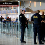 A San Diego Harbor police officer chats with Homeland Security officers while on patrol at Lindbergh Field airport in San Diego