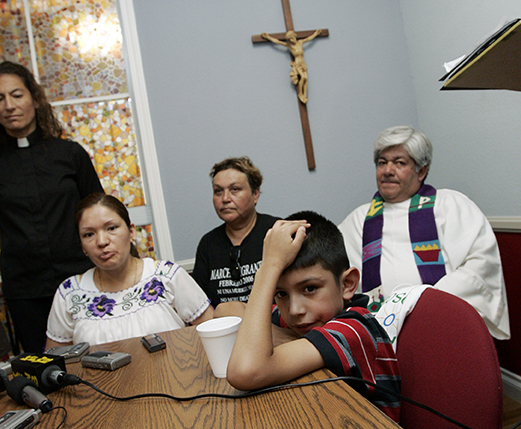 Elvira Arellano, left, an illegal immigrant from Mexico who has taken refuge in a Chicago church to avoid deportation, answers reporters' questions as her 8-year-old son Saul sits at the table with others involved in the sanctuary movement at Nuestra Senora de Los Angeles church in Los Angeles. (AP Photo/Reed Saxon)