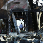 A security official investigates the aftermath of a fire at the Victoria Islamic Center mosque in Victoria, Texas